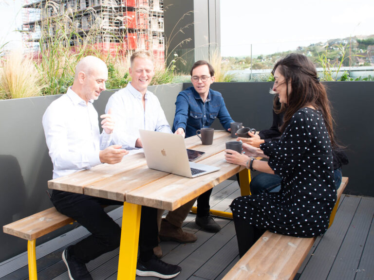 David Dand Coreus Founder & Director conversing with colleagues